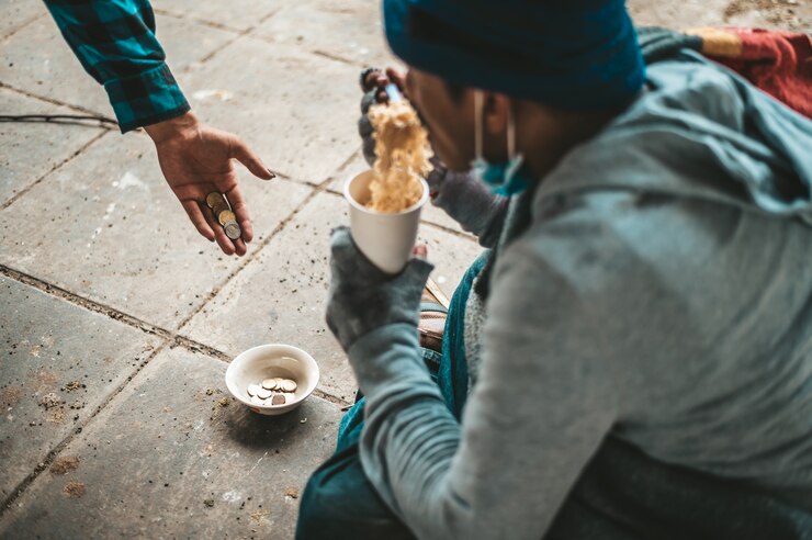 Feeding crime beggars eating